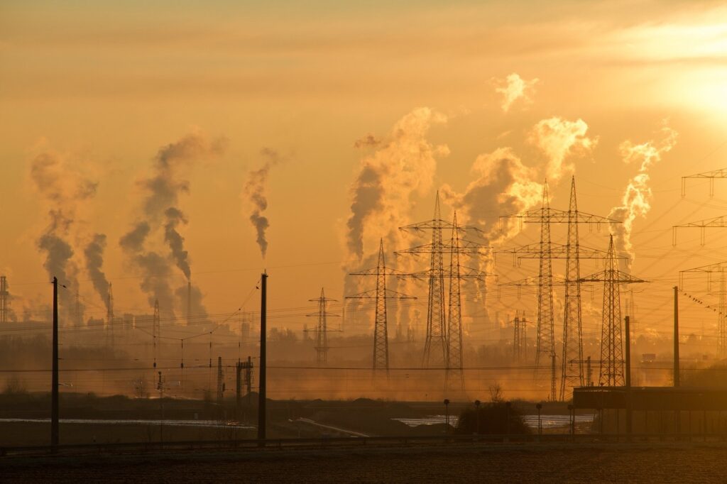 wide shot of factories producing smoke