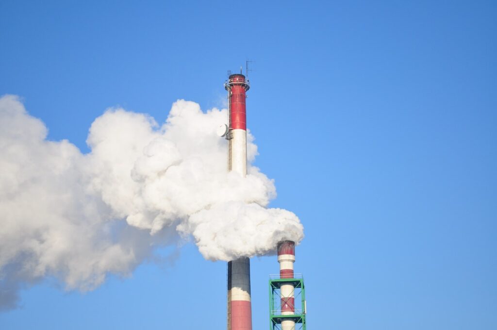 white smoke coming from a factory